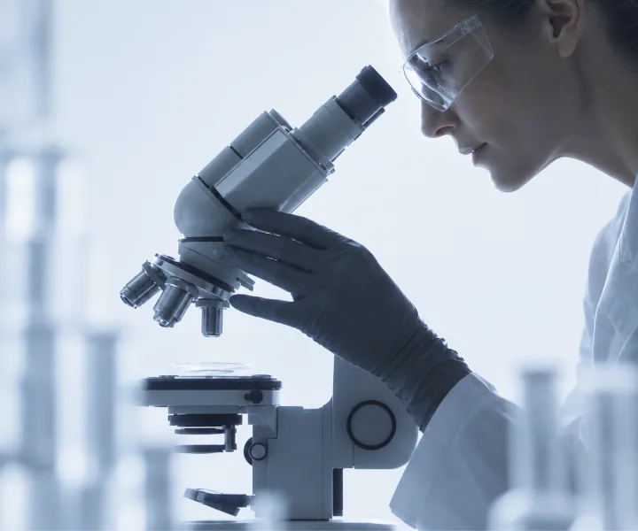 Researcher looking through a microscope in a laboratory
